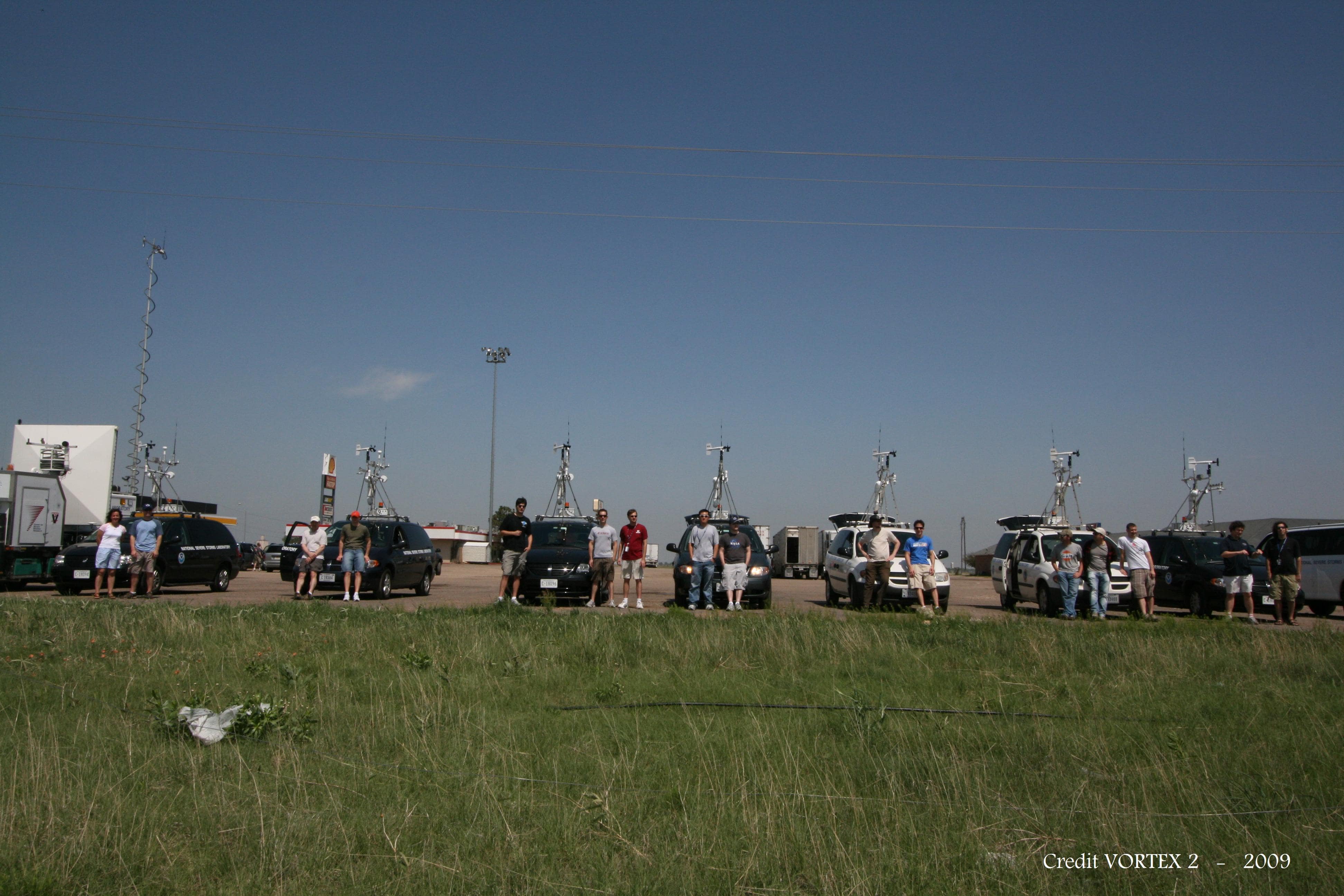 VORTEX-2 researchers standing in a row in front of their assigned technology-equipped vehicles during a field deployment on May 12, 2009.